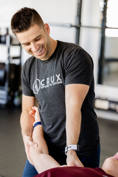 Chiropractor performing an arm adjustment on a patient at a clinic in St. George, Utah.