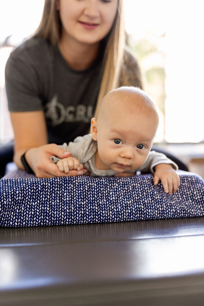 Chiropractor gently performing an adjustment on an infant at a clinic in St. George, Utah.