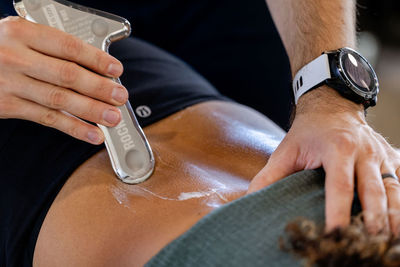 A chiropractor in St. George, Utah performs instrument-assisted soft tissue mobilization (IASTM) on a patient's back